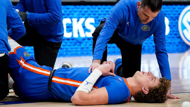 Florida center Micah Handlogten is helped by medical staff after suffering an injury.